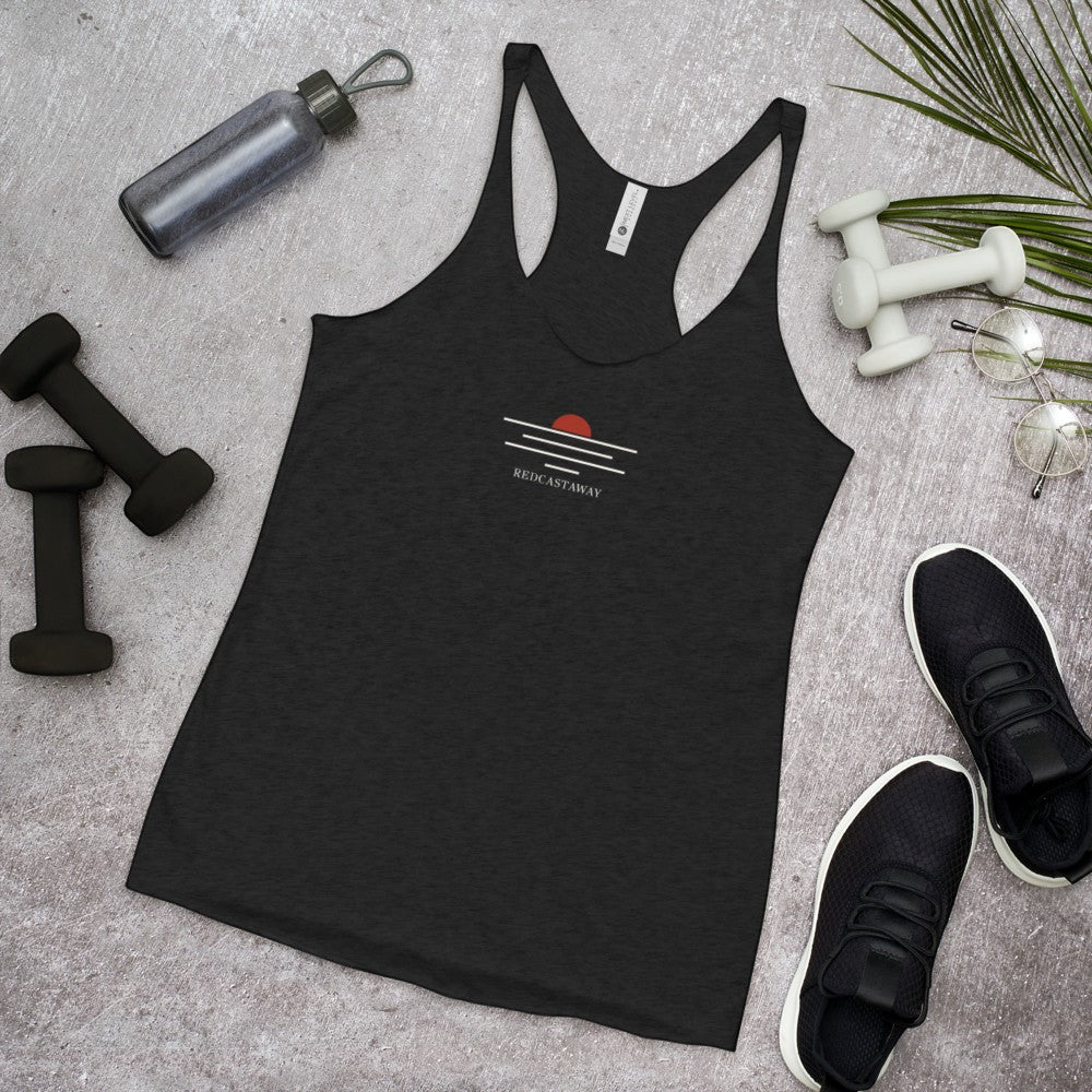 Redcastaway women's black racerback tank top made from a poly-cotton blend with a subtle sunset graphic and raw edge seams.