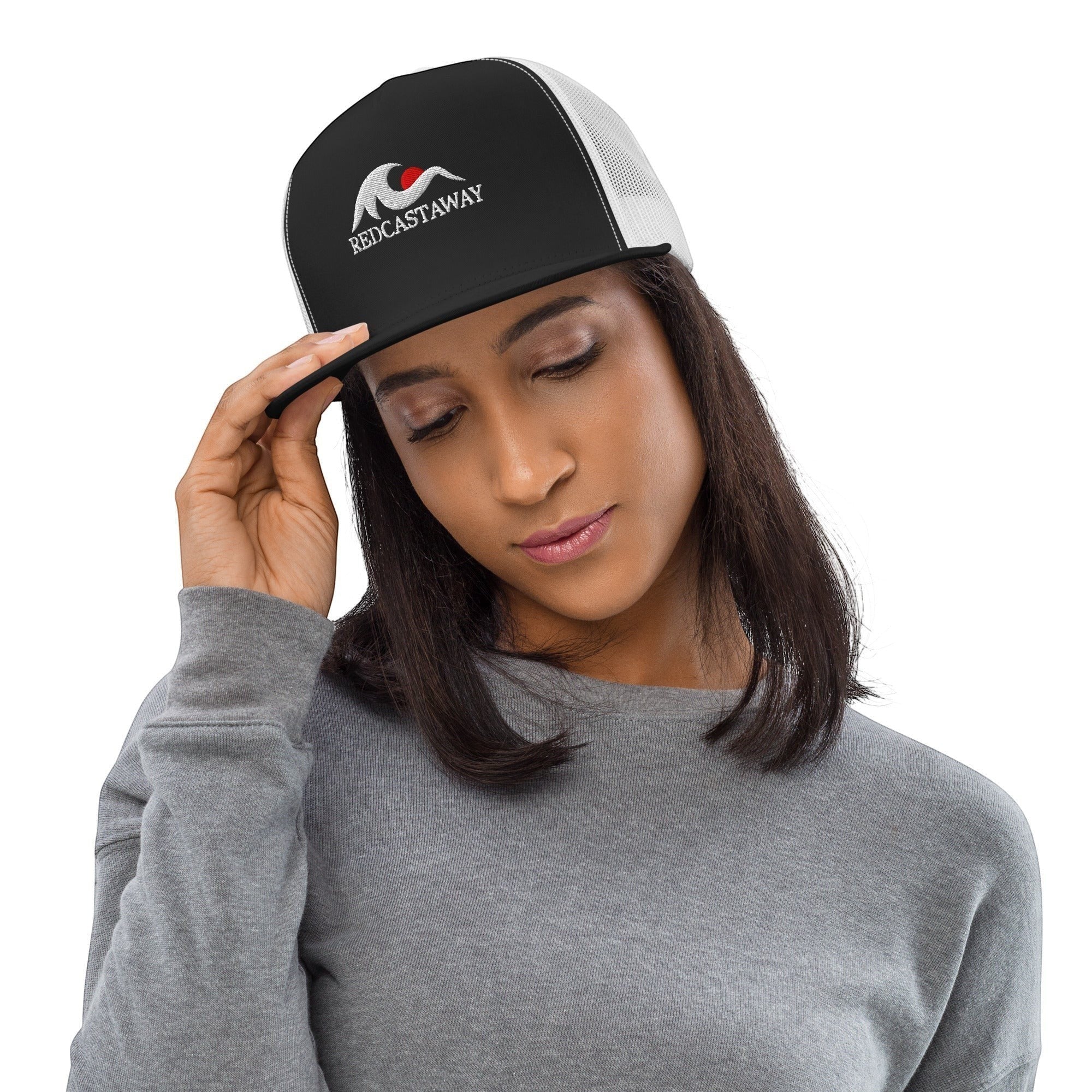 Redcastaway trucker cap with black front panel, white mesh back, and embroidered logo. Features a flat bill and snapback closure.