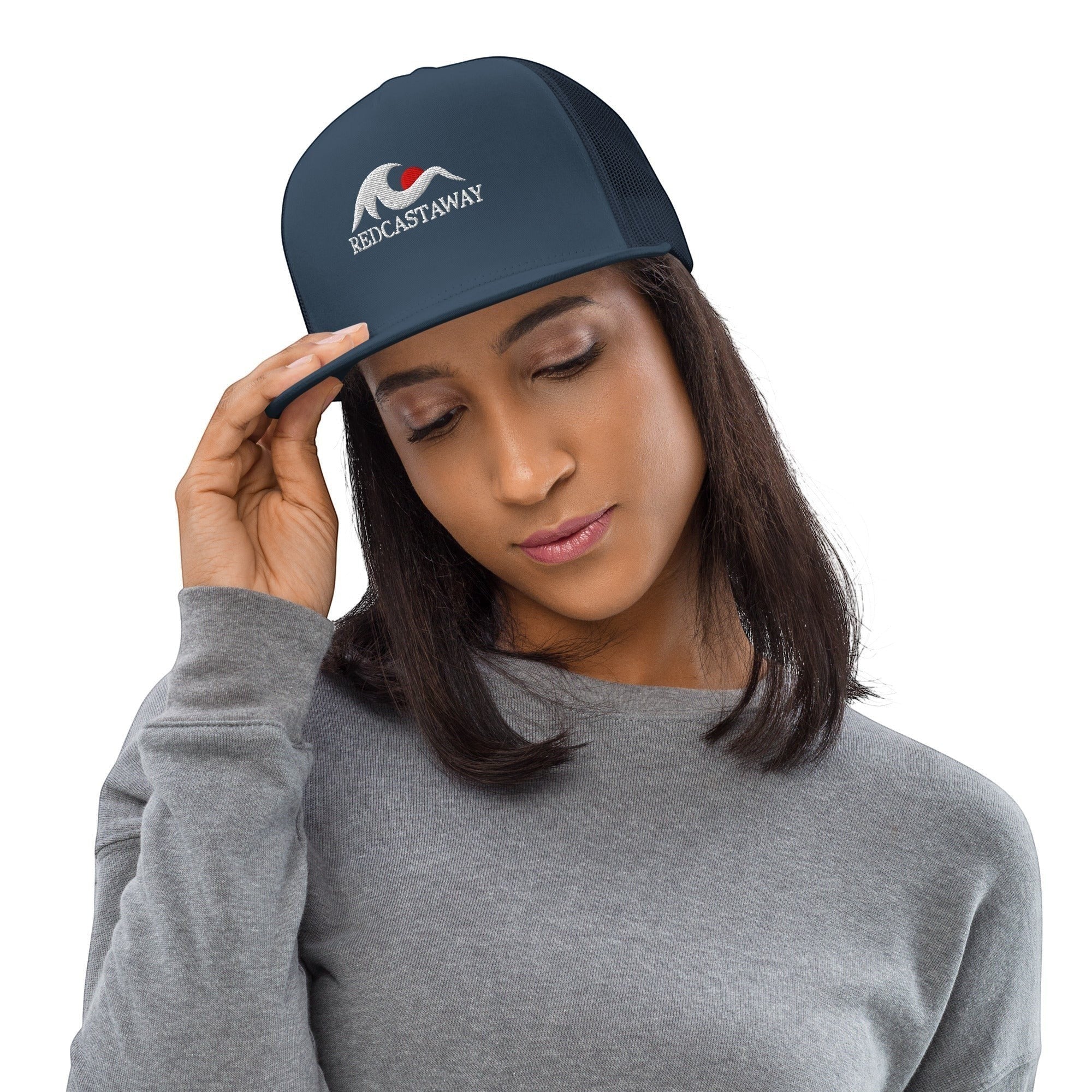 Redcastaway dark navy trucker cap with flat bill and embroidered logo, made of cotton, nylon, and polyester blend.
