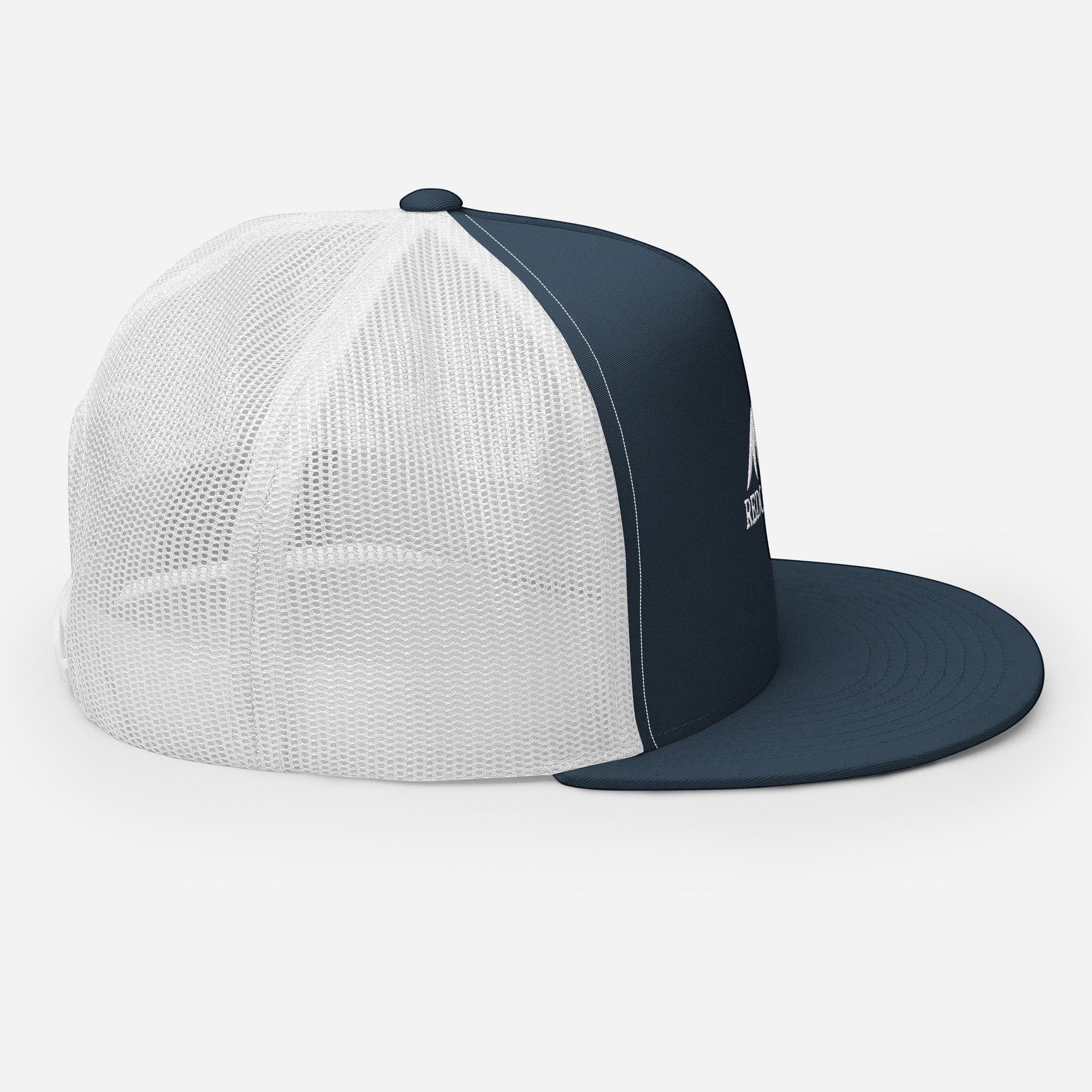Redcastaway navy blue and white trucker cap with flat bill and snapback closure. Cotton, nylon, polyester blend.