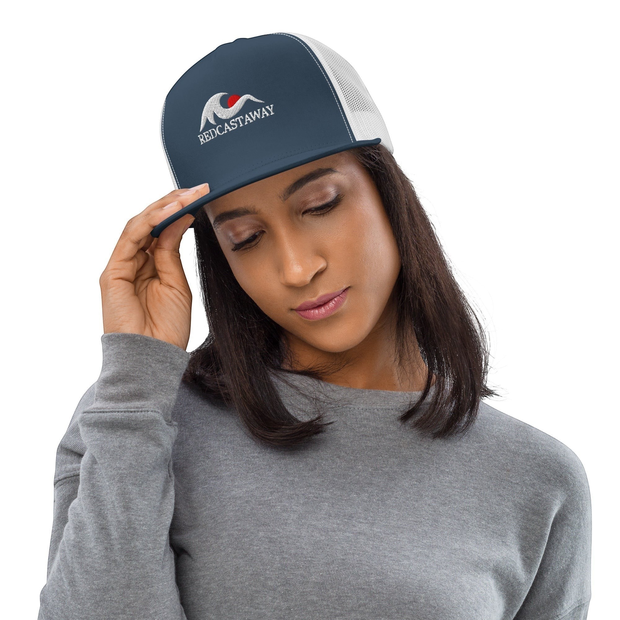 Redcastaway Drift Trucker Cap in navy blue with white mesh back and embroidered logo. Features a flat bill and snapback closure.