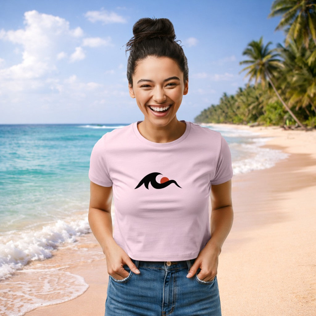 Redcastaway	exttrademark women's light pink cropped baby tee with a black wave and red sun graphic. 60/40 cotton-poly blend.