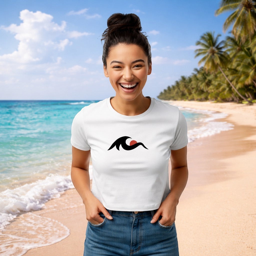 Redcastaway women's white cropped baby tee with a black wave and red sun graphic. Made of 60% cotton, 40% polyester.