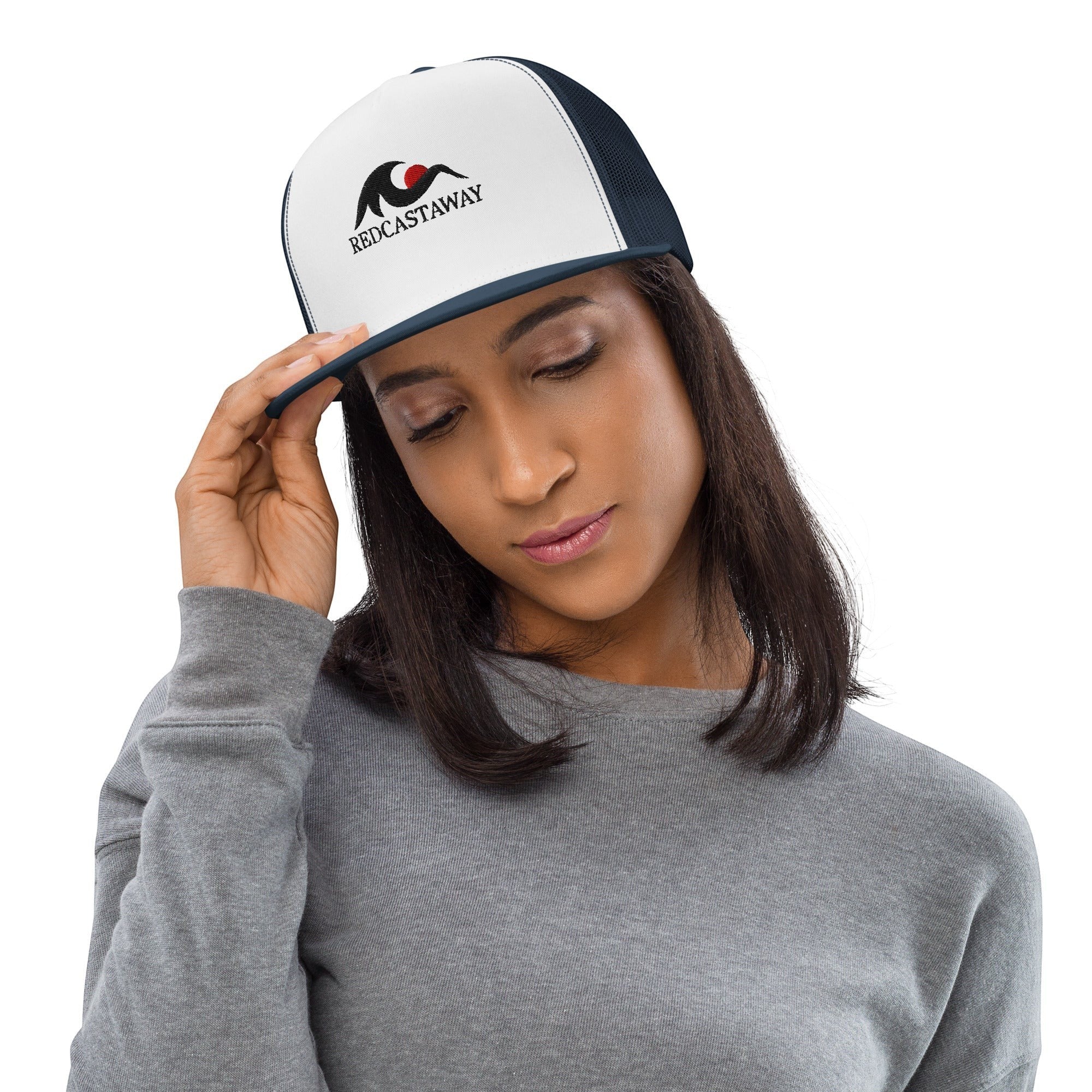 Redcastaway™ white trucker cap with navy mesh back and flat bill, featuring embroidered logo. Cotton blend.